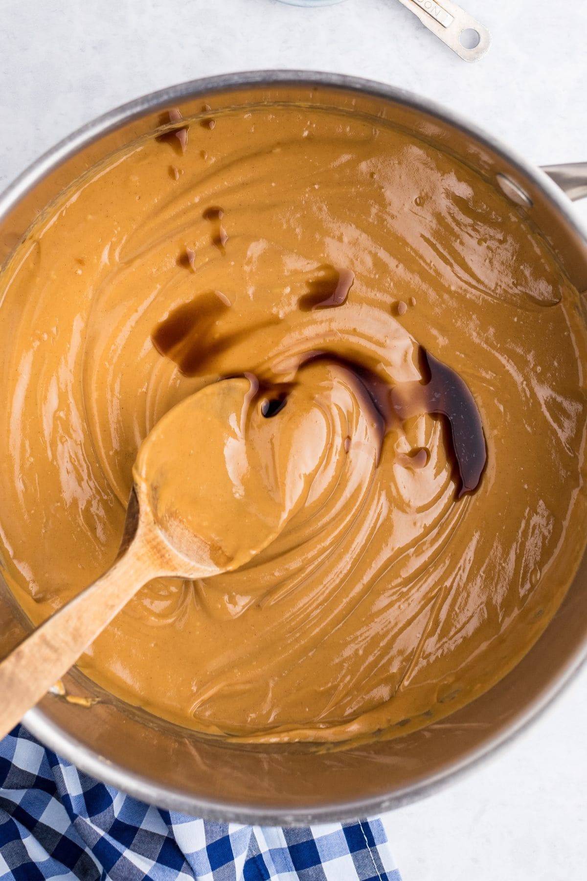 melt peanut butter in a pan and add vanilla extract.