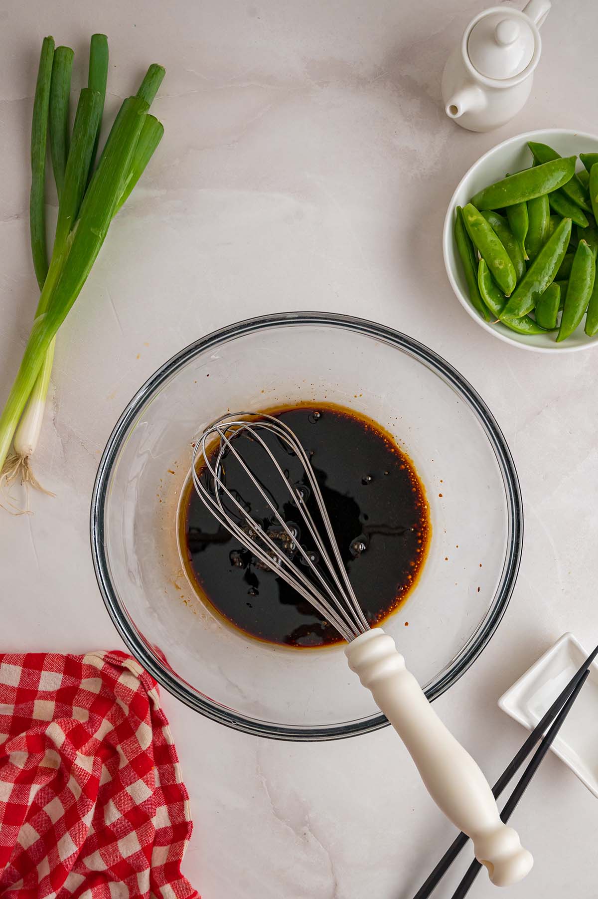 Whisk in a bowl of Asian noodle salad dressing.