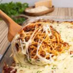 Cheesy baked spaghetti served with meat sauce and melted mozzarella.