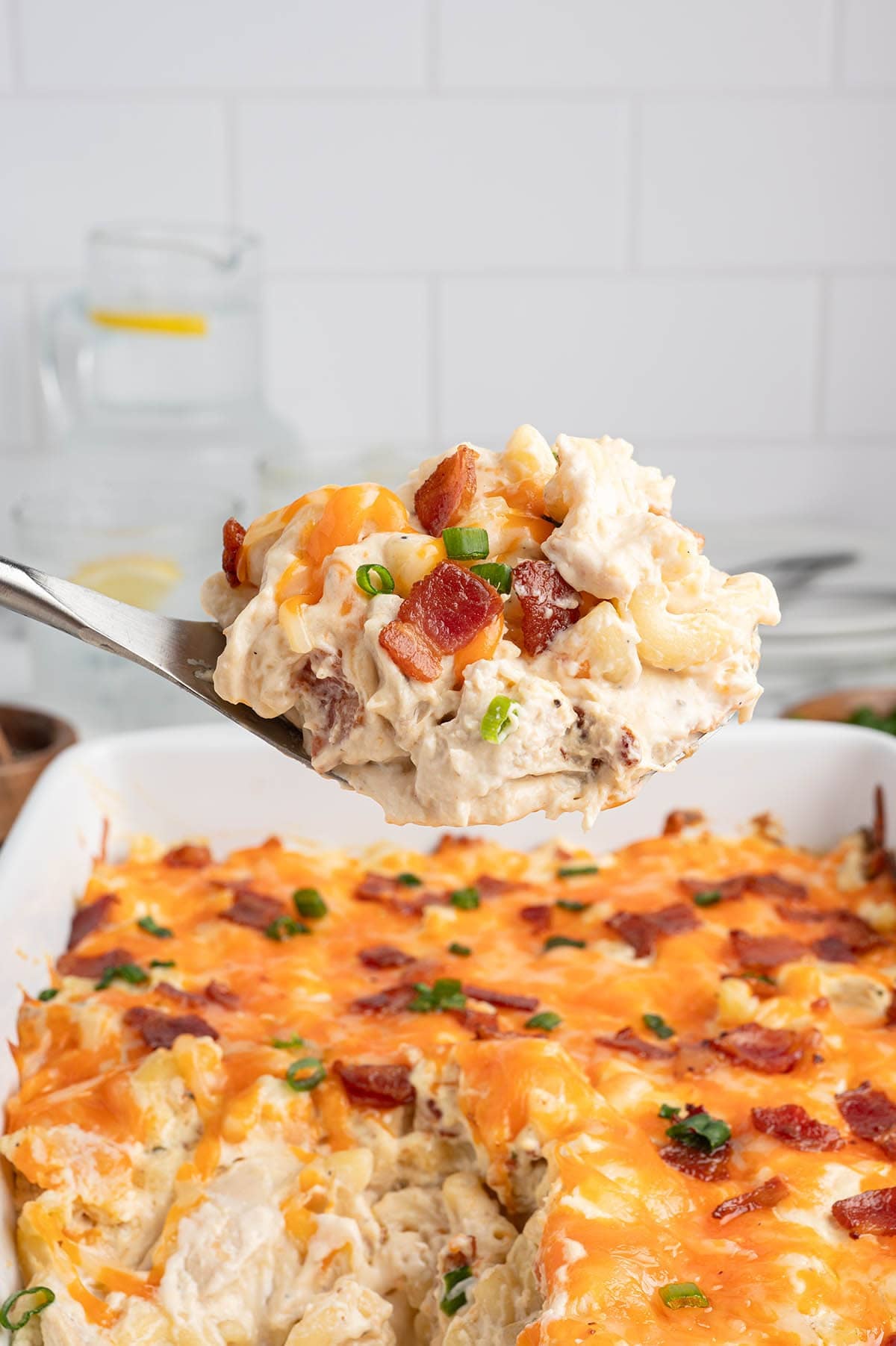 Close-up of a spoonful of creamy crack chicken casserole with bacon and cheese.
