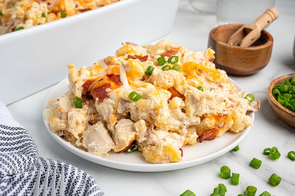 Plated serving of crack chicken casserole garnished with green onions.