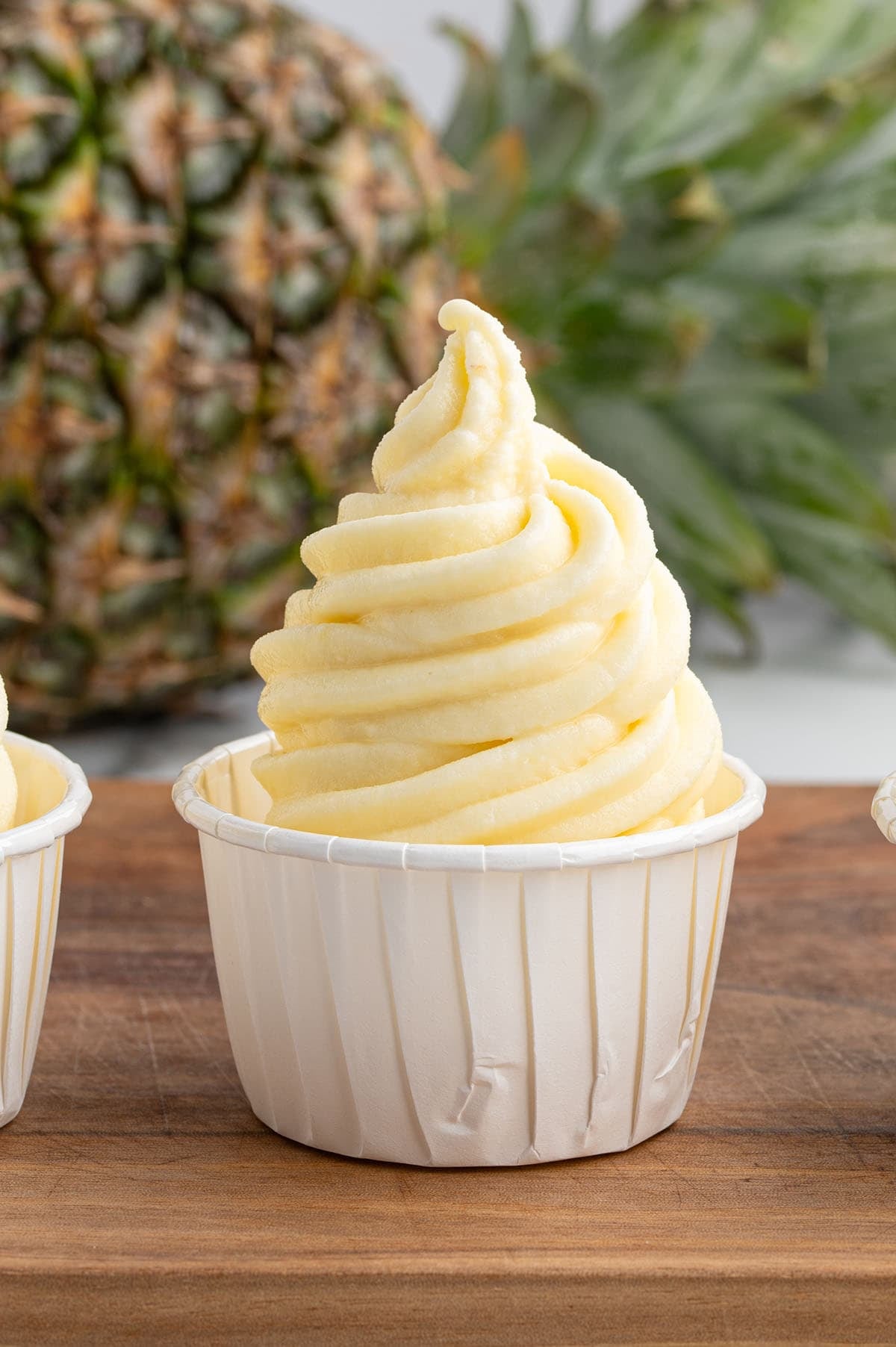 dole whip in white paper cup. 
