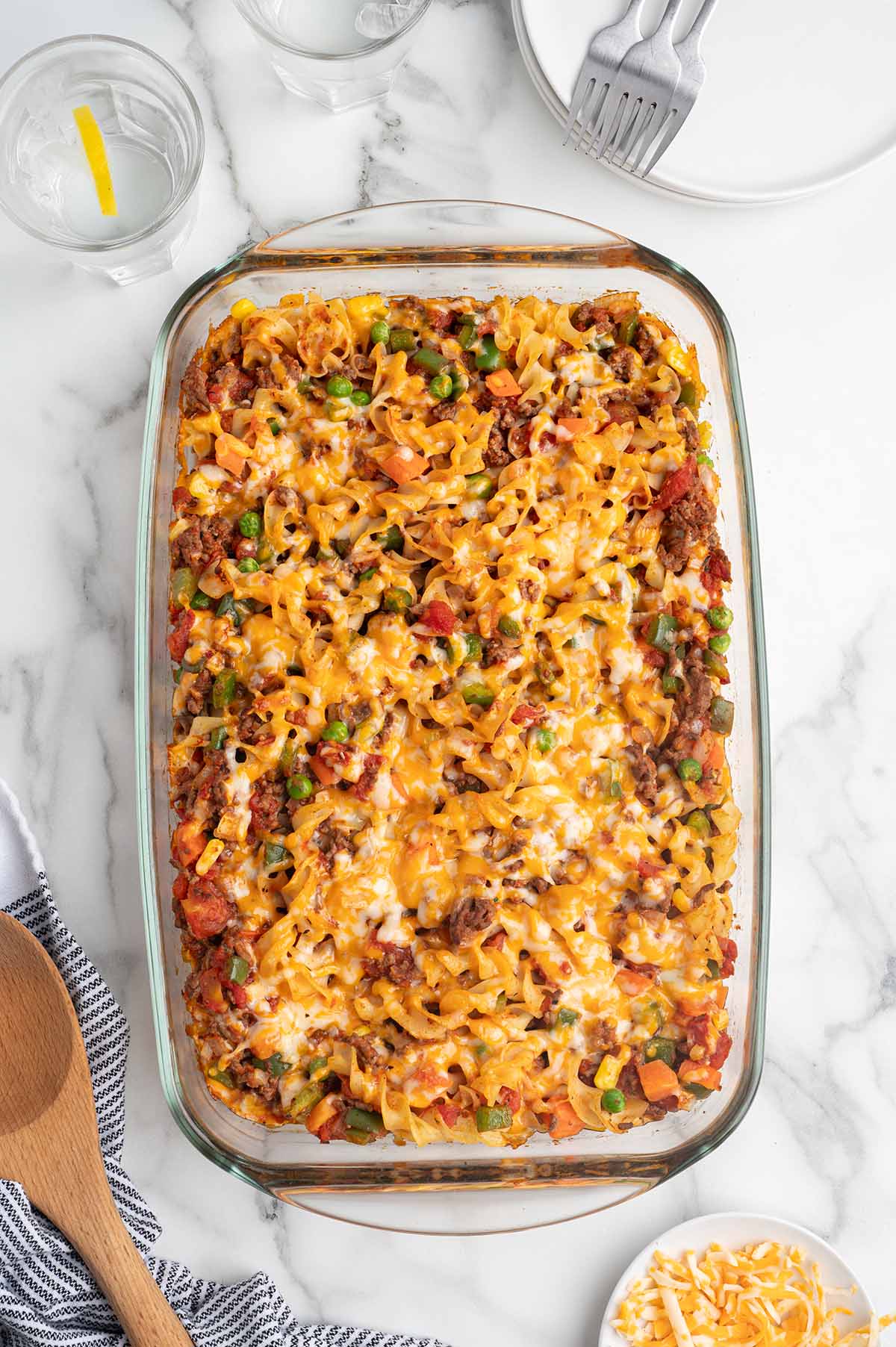Overhead view of baked hamburger casserole with egg noodles and melted cheese.