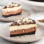 a slice of triple chocolate cheesecake on the plate.