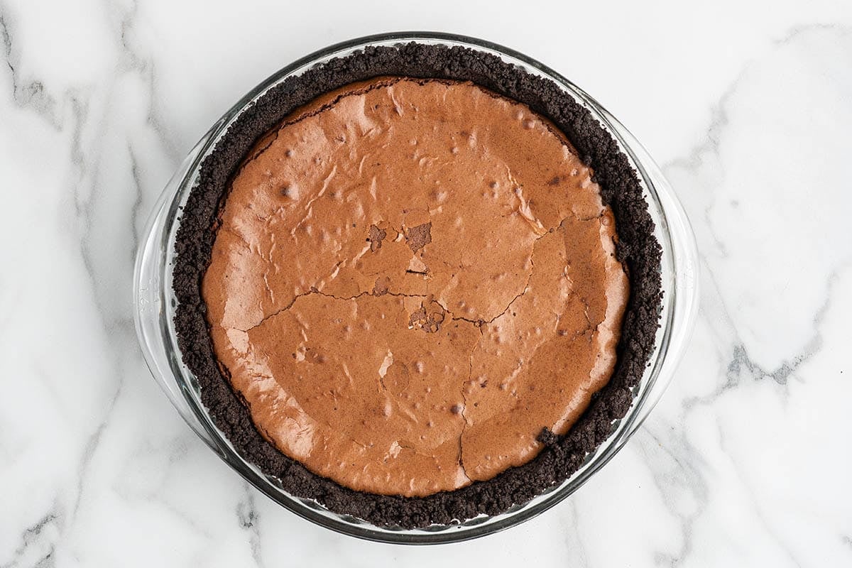 Baked chocolate mud pie filling with a cracked, set surface.