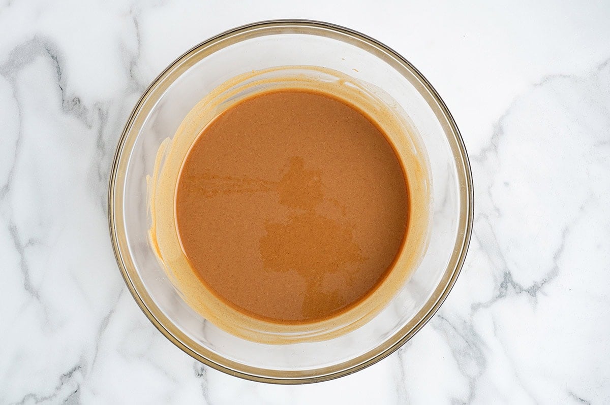 Peanut butter fudge mixture in a glass mixing bowl.