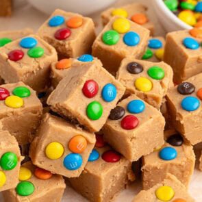 Peanut butter fudge squares topped with colorful M&M's candies.