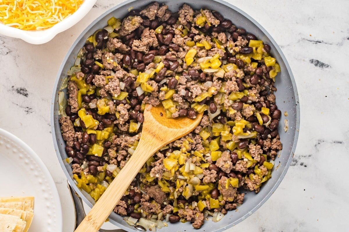 Beef, black bean, and green chile filling for enchilada casserole.