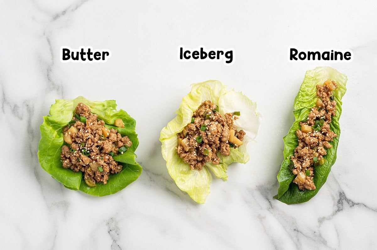 Asian chicken lettuce wraps served in butter, iceberg, and romaine lettuce leaves.