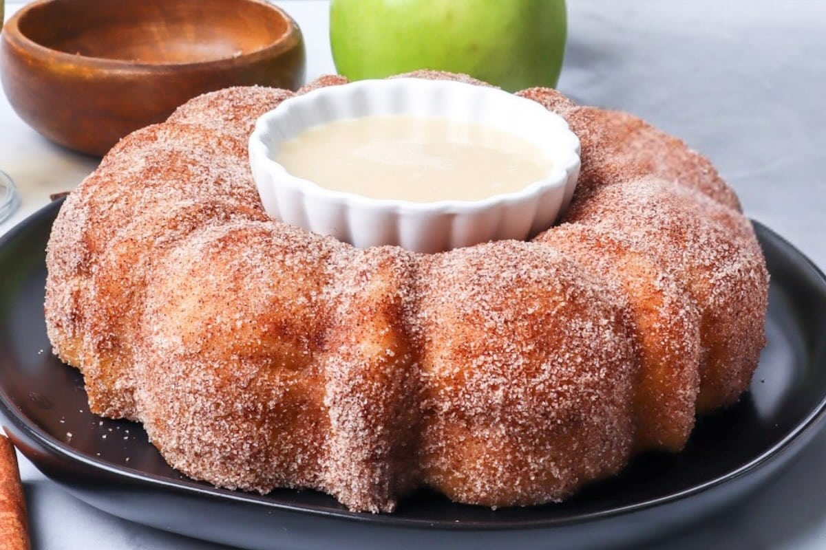 apple cider donut cake with sauce in the middle.