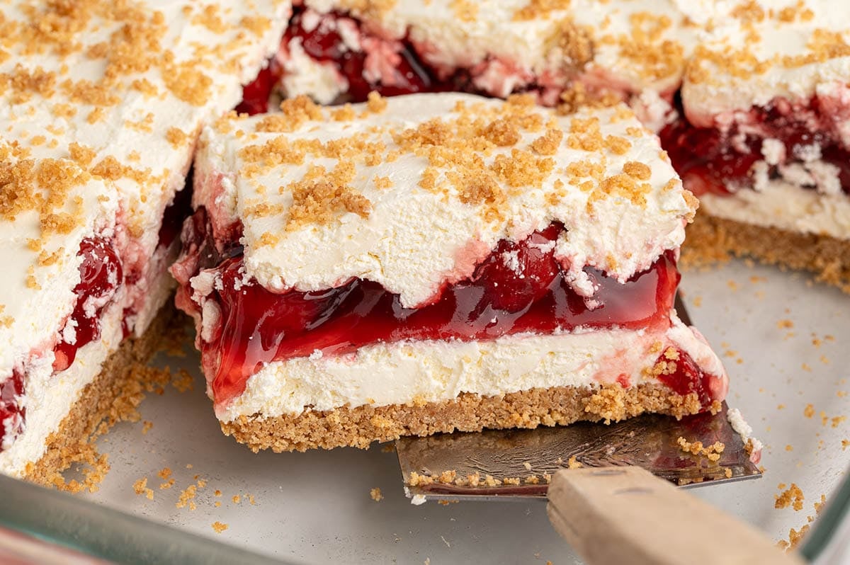 Close-up of a sliced cherry yum yum dessert with graham cracker crumb topping.
