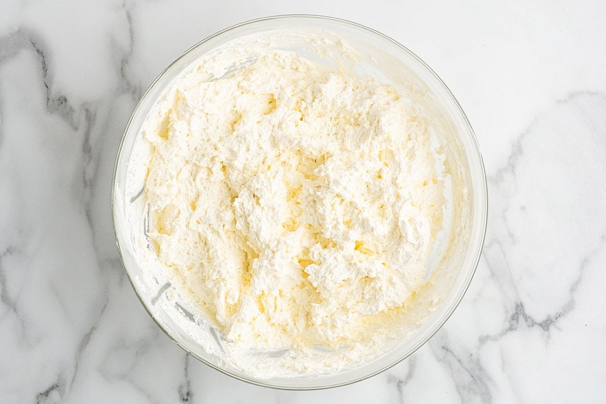 Whipped cream cheese filling mixed in a glass bowl.