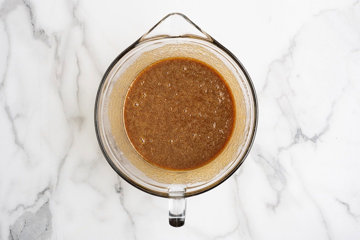 Pecan pie filling mixture in a glass mixing bowl.
