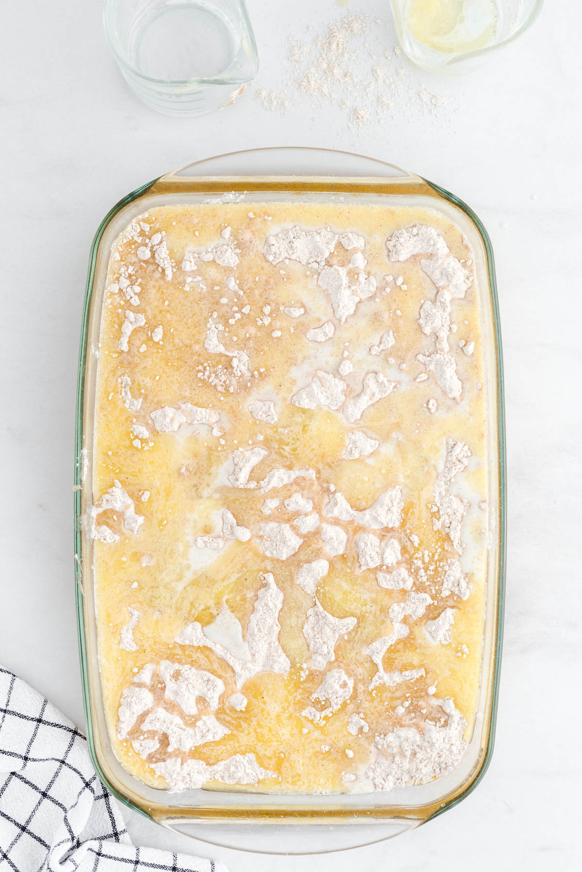 Pumpkin dump cake with melted butter poured over the dry cake mix before baking.