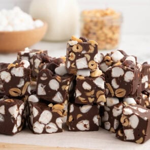 Cut the chilled Rocky Road Fudge into squares and serve. Each bite is packed with rich chocolate, fluffy marshmallows, and crunchy nuts.