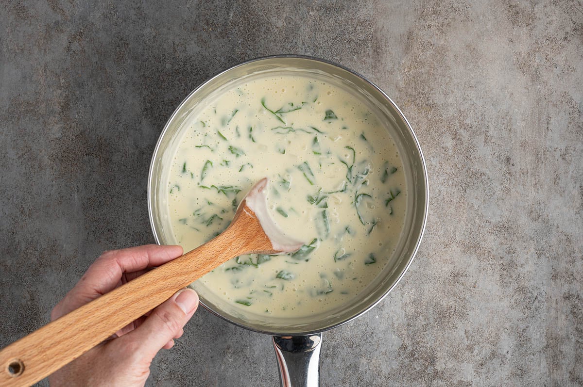 Stir fresh spinach into the creamy white sauce and cook just until wilted before layering it into the lasagna.