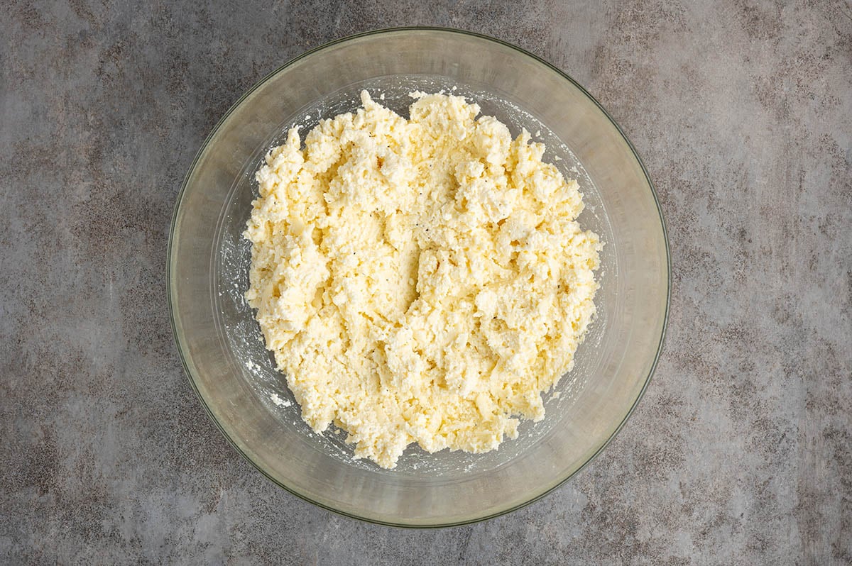 Mix the ricotta, egg, Parmesan, and seasonings until smooth and well combined to create the creamy cheese filling for the lasagna.