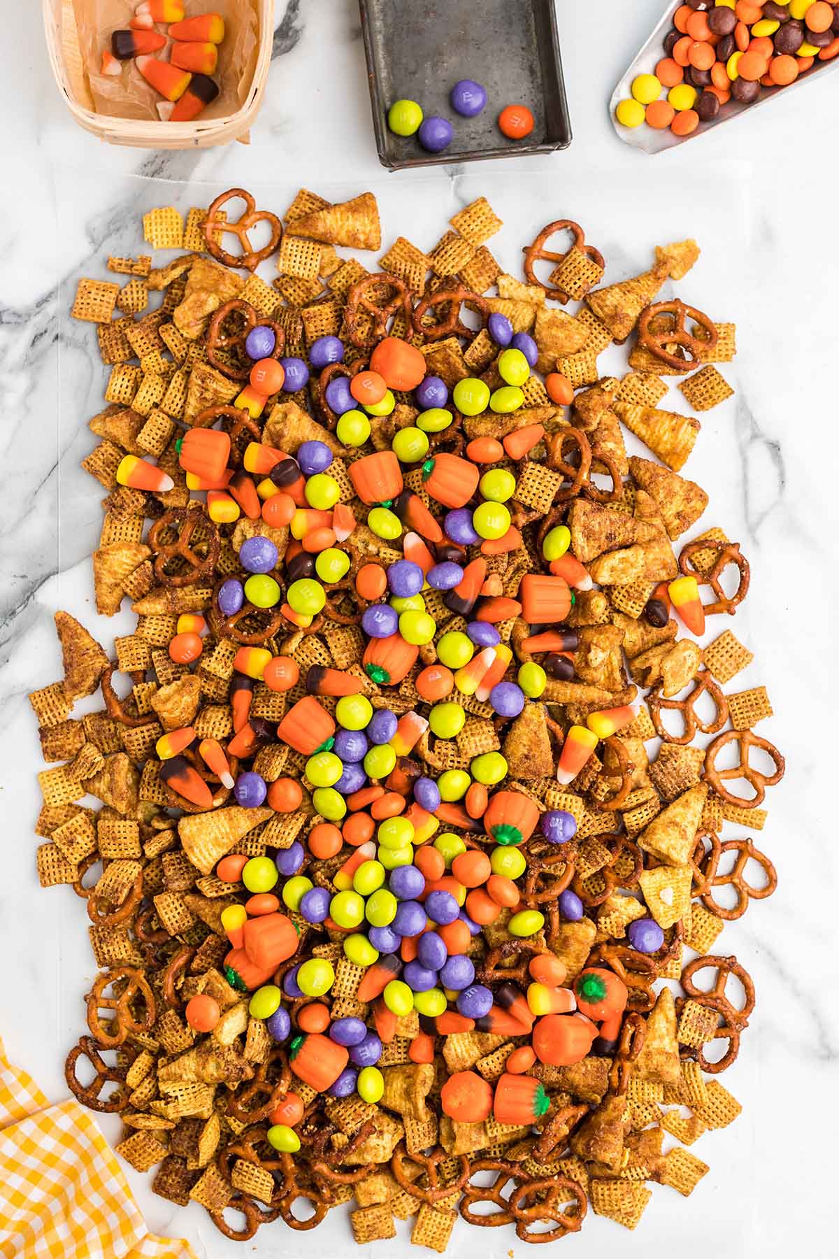 Halloween Chex mix topped with candy corn and M&Ms.