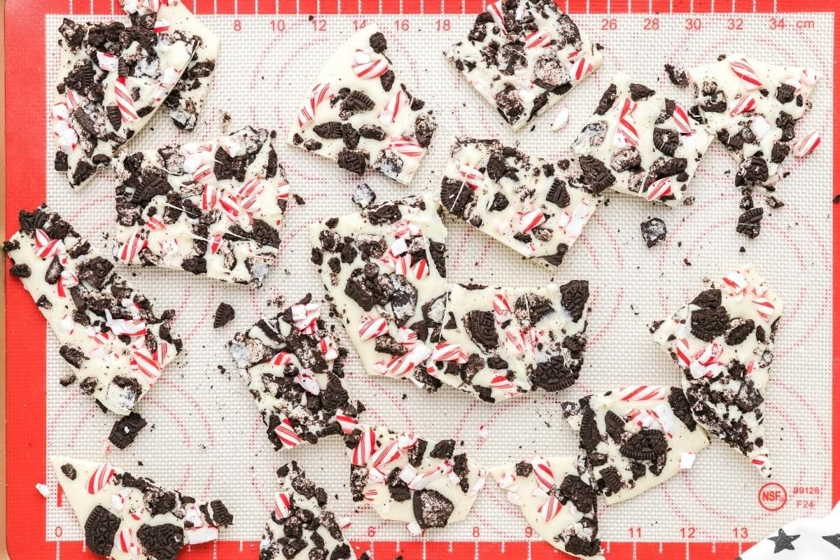 Broken pieces of Oreo peppermint bark on a baking sheet.