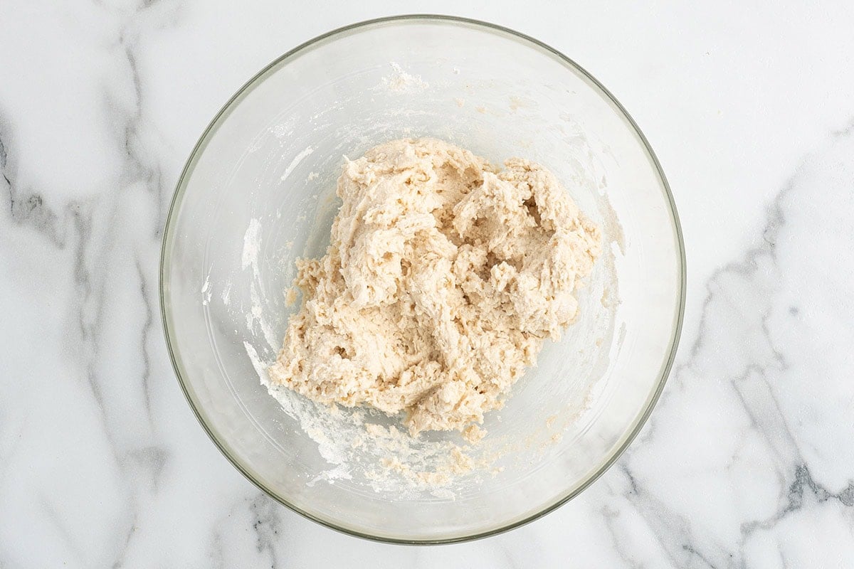 Dumpling dough mixed in a glass bowl.