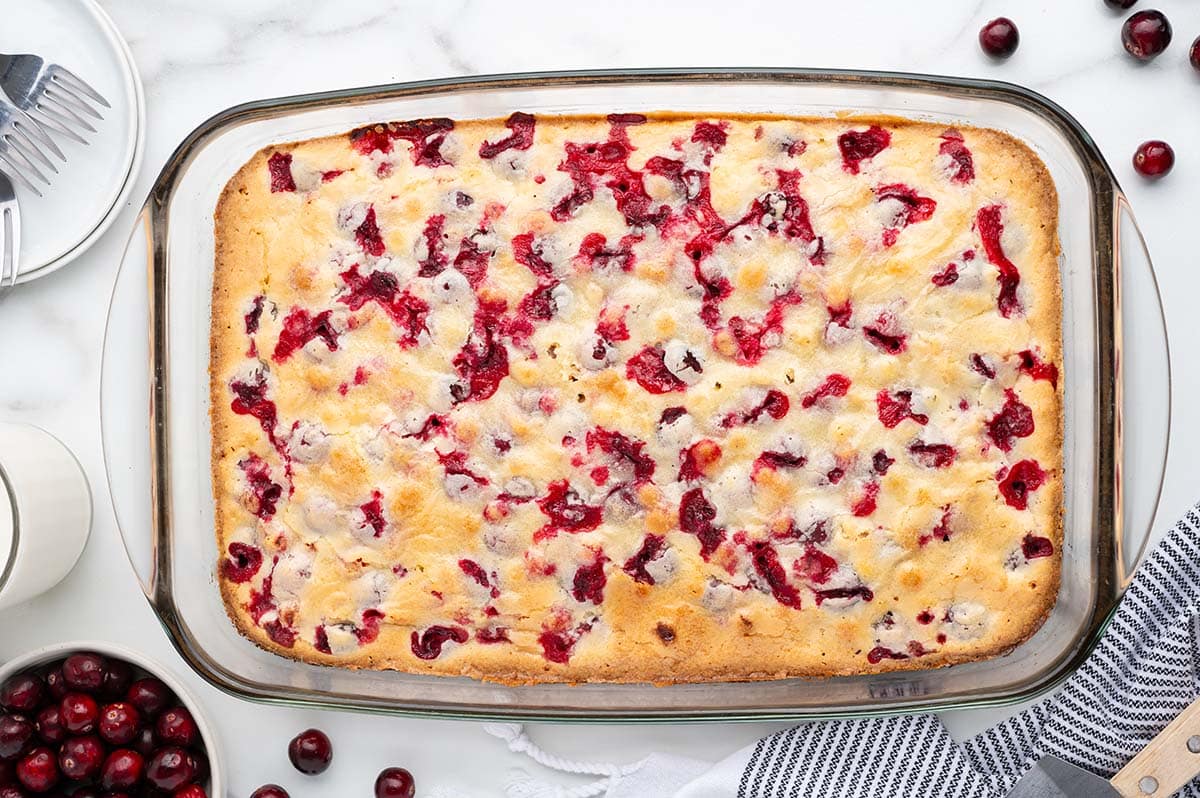 Baked cranberry cake in a glass baking dish.