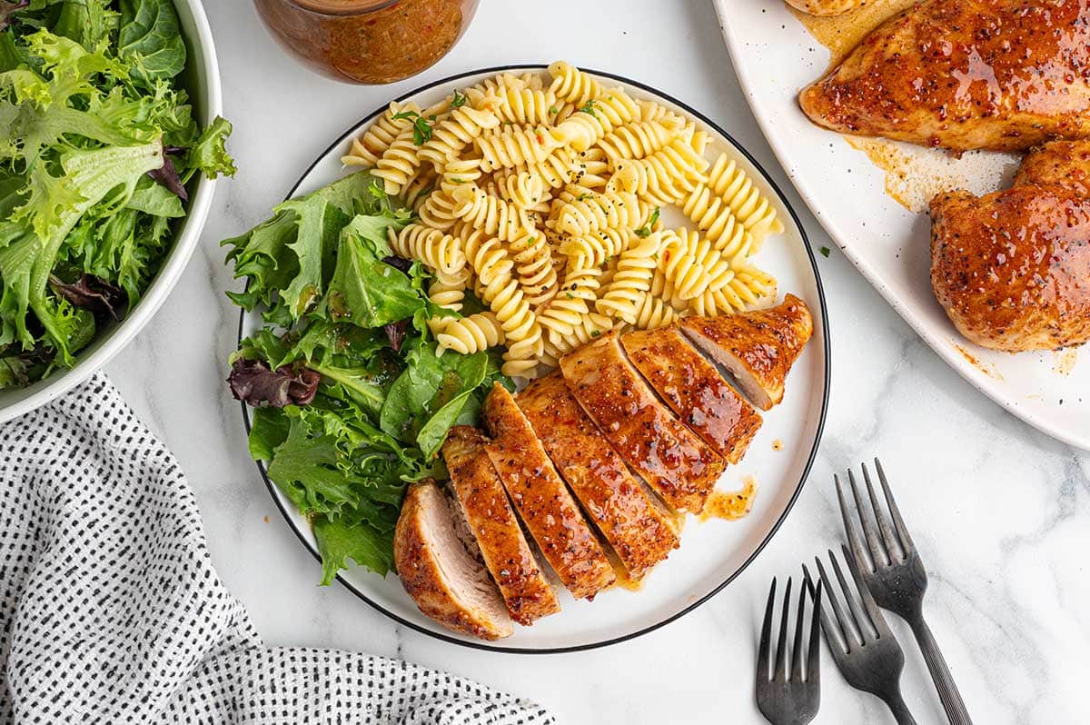 Italian chicken with pasta and mixed greens.