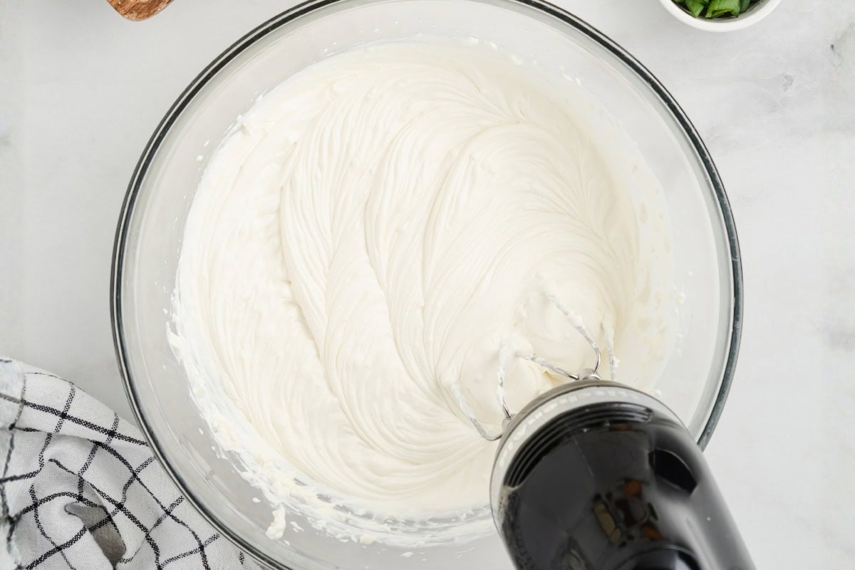 alapeño popper dip mixture spread in a baking dish before baking.