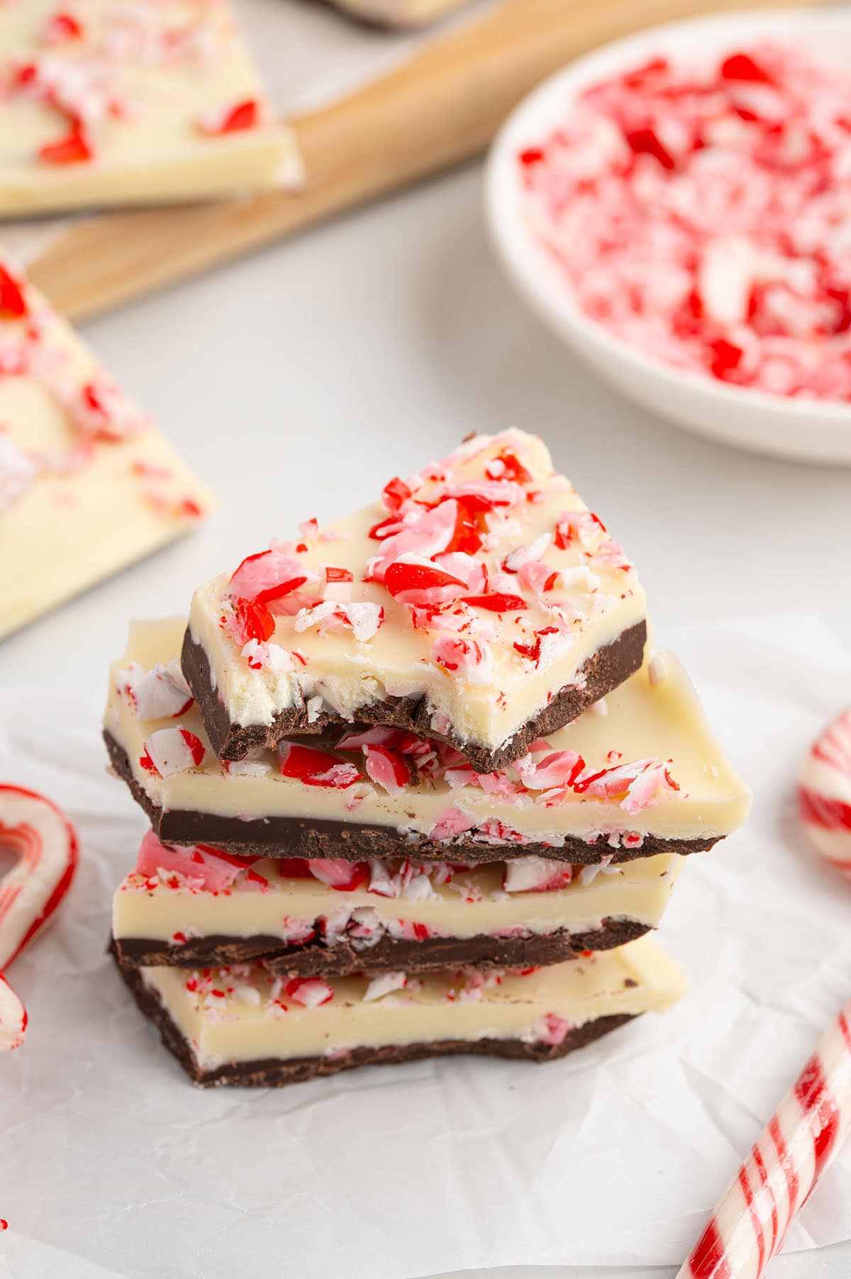 Peppermint bark stacked with crushed candy canes.