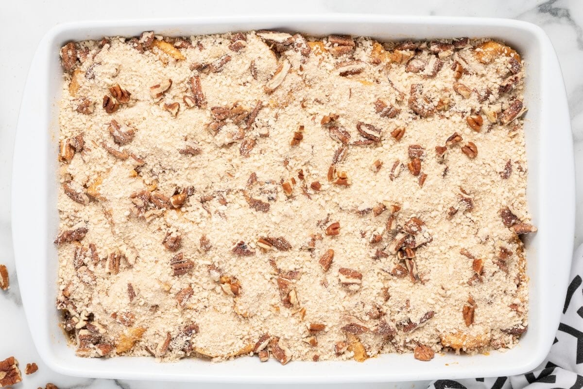Baked pumpkin French toast casserole with pecan streusel topping.