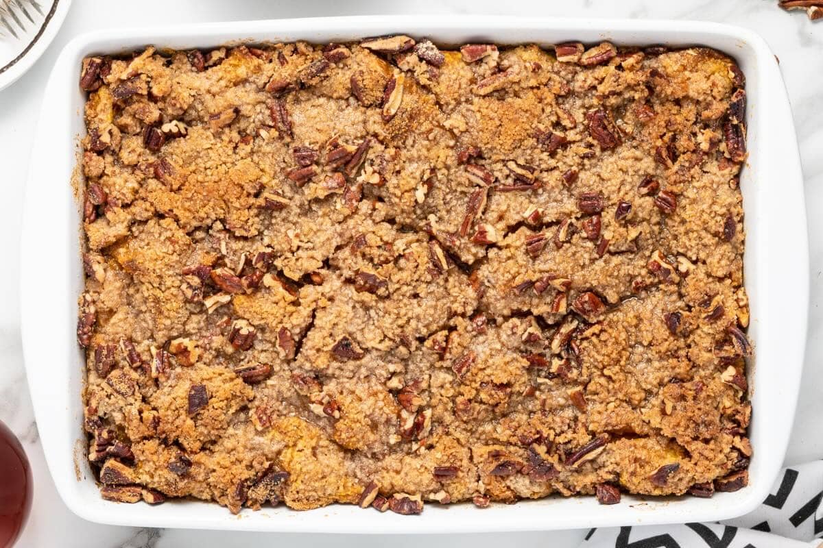 Baked pumpkin French toast casserole with pecan streusel topping.