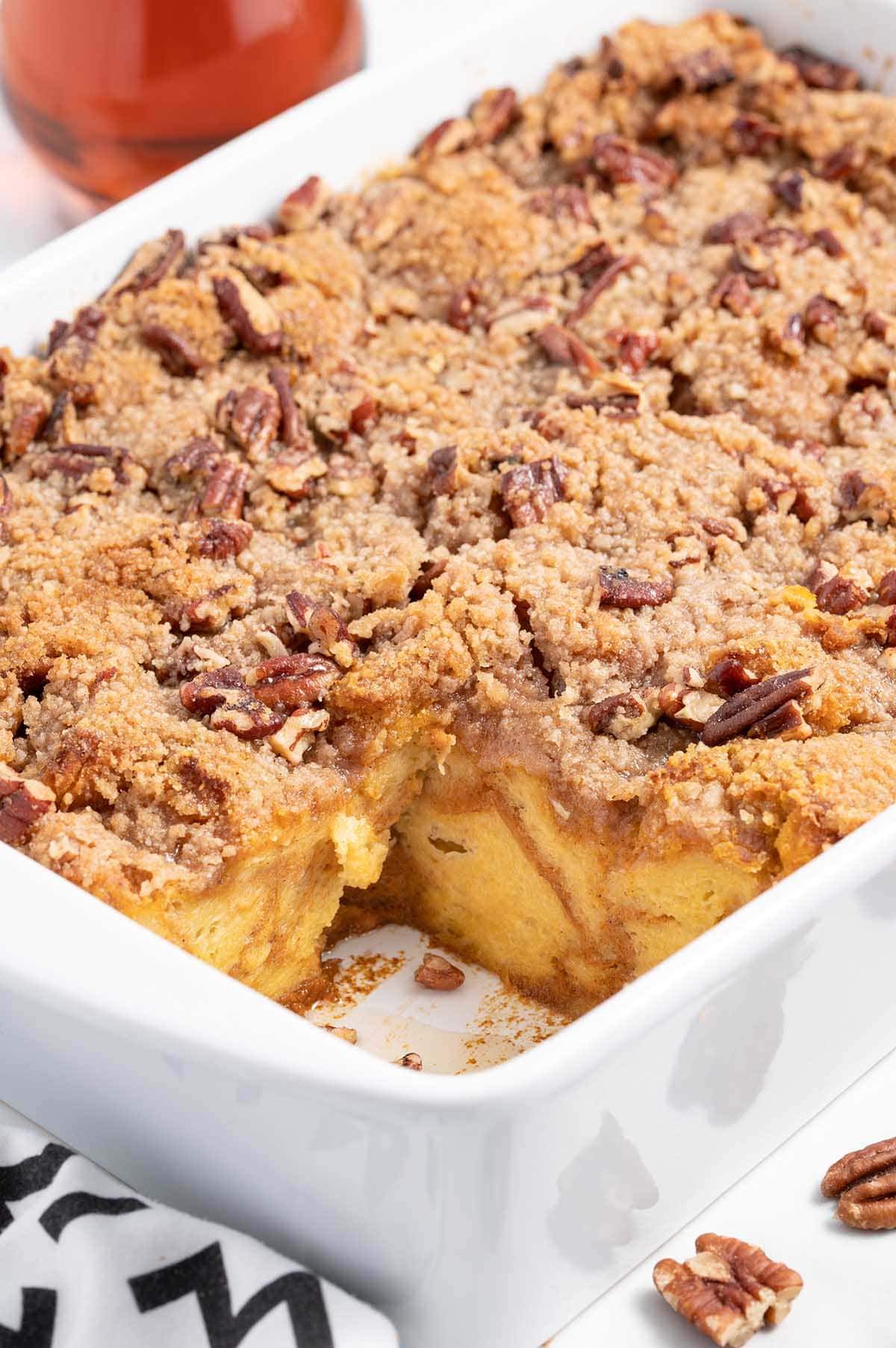 Baked pumpkin French toast casserole with a slice removed.