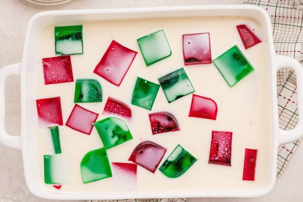 Red and green Jello pieces in a creamy white mixture.