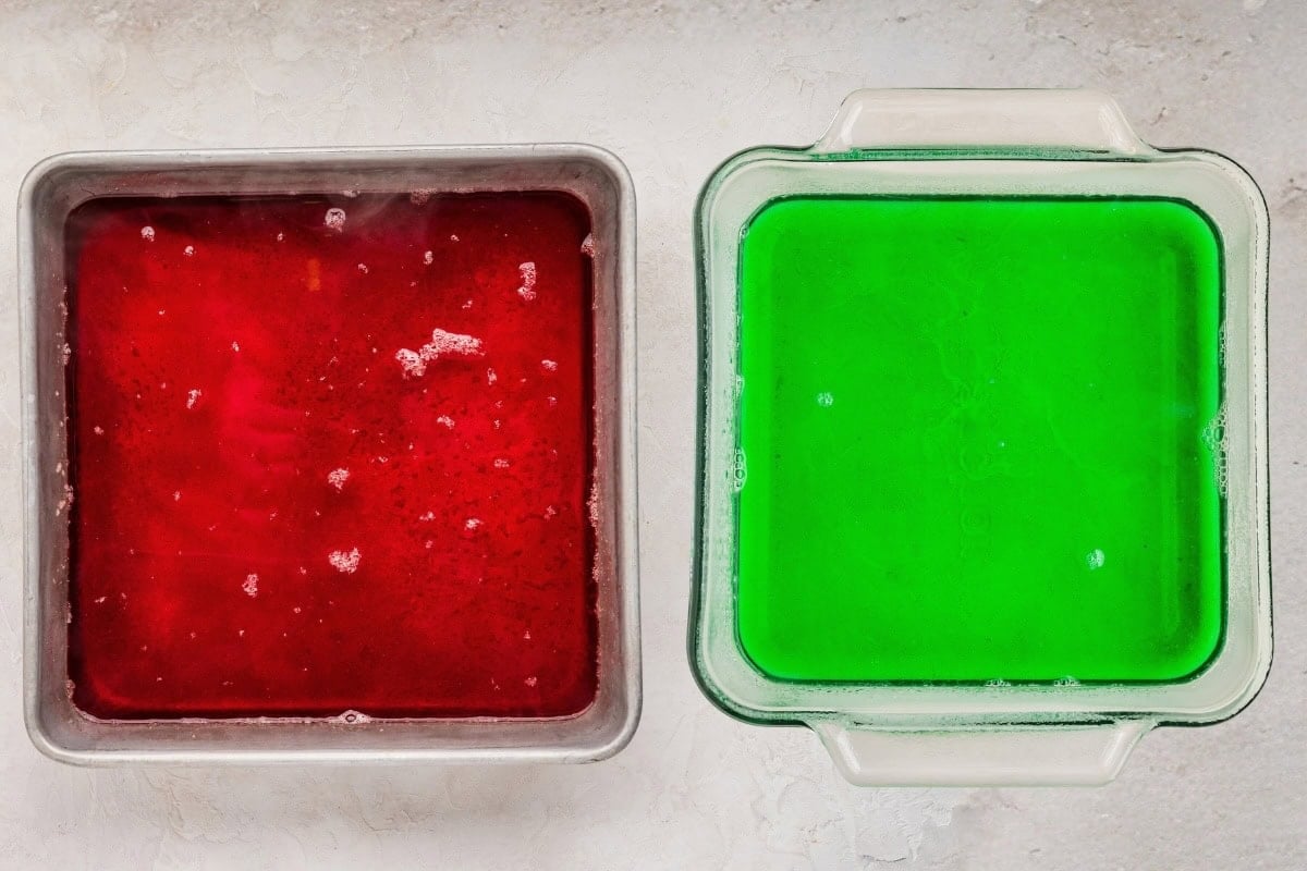 Red and green Jello set in two baking dishes.