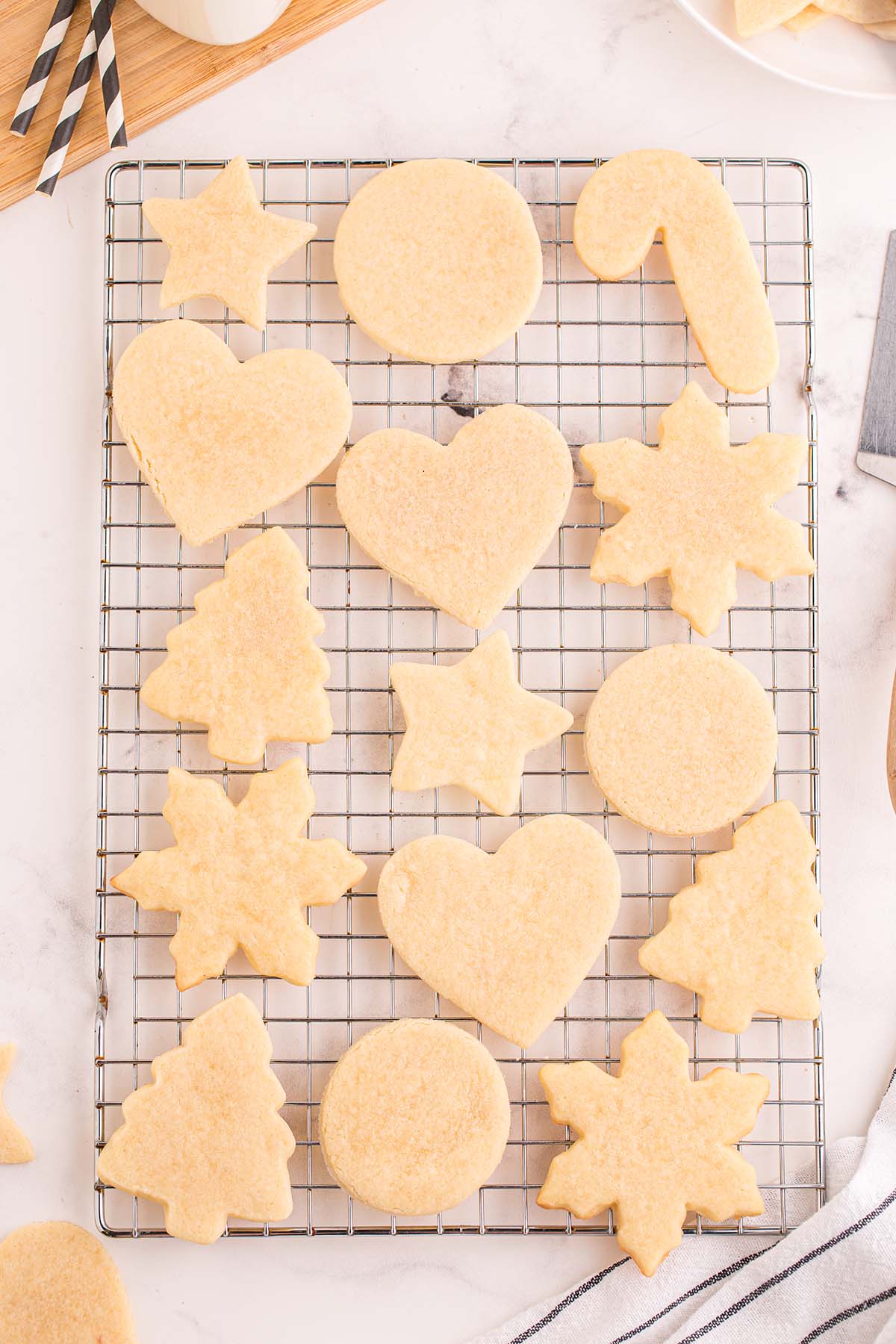 Baked cut out sugar cookies cooling on a wire rack.
