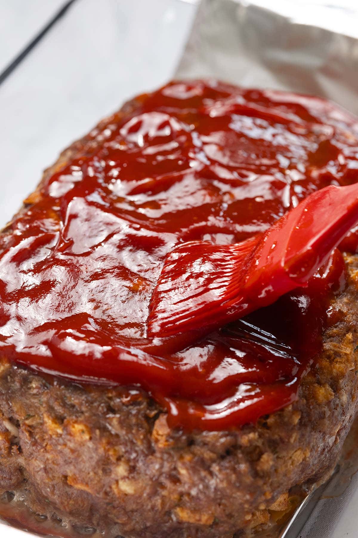 Stove Top stuffing meatloaf brushed with sauce.