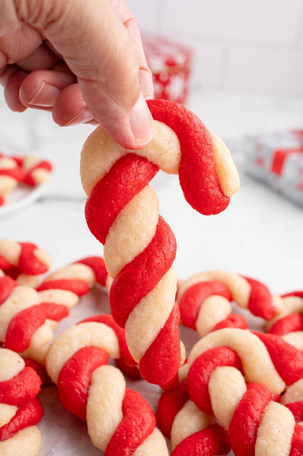 hand holding candy cane cookies. 
