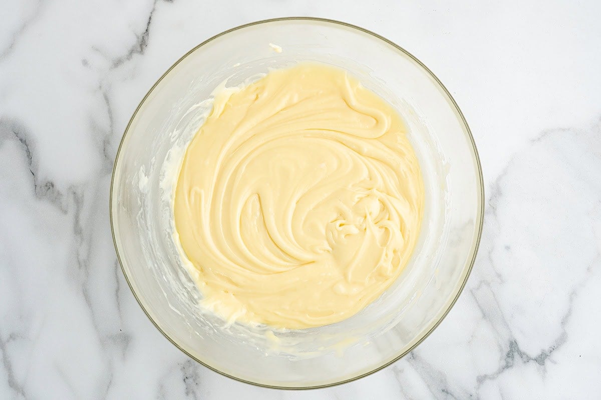 Creamy maple fudge mixture in a glass bowl.