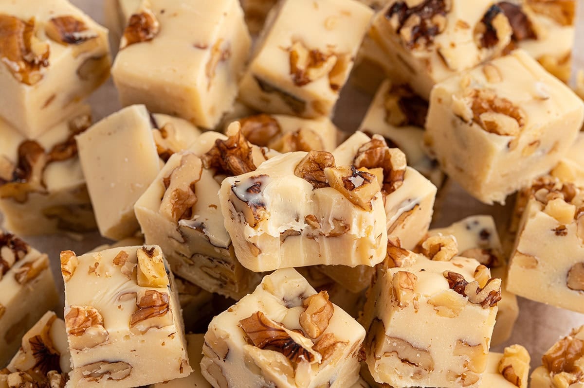Maple walnut fudge squares topped with chopped walnuts.