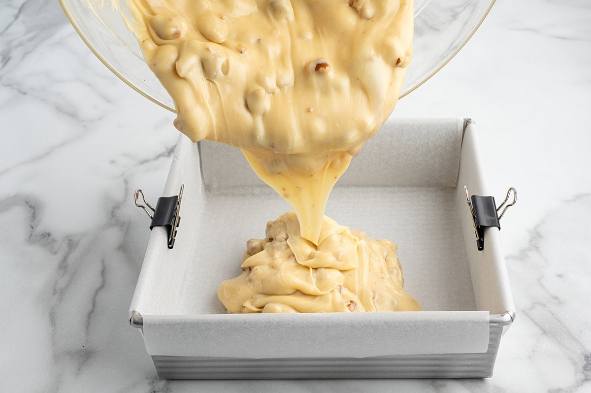 Maple walnut fudge mixture poured into a lined pan.