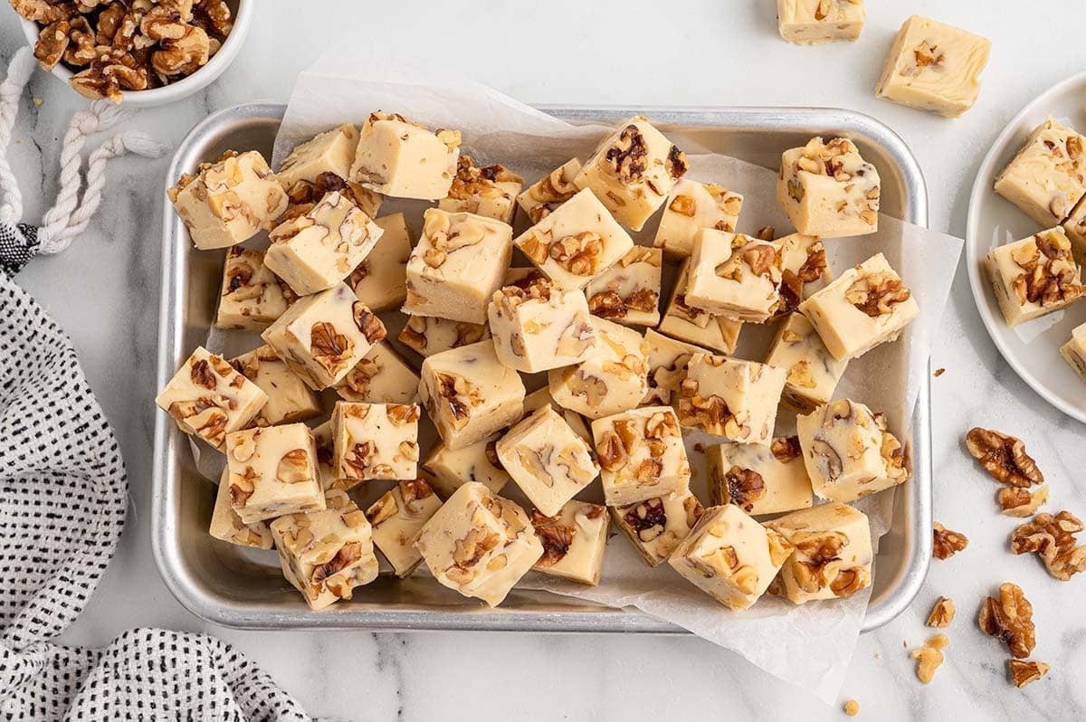Maple walnut fudge pieces arranged on a baking sheet.
