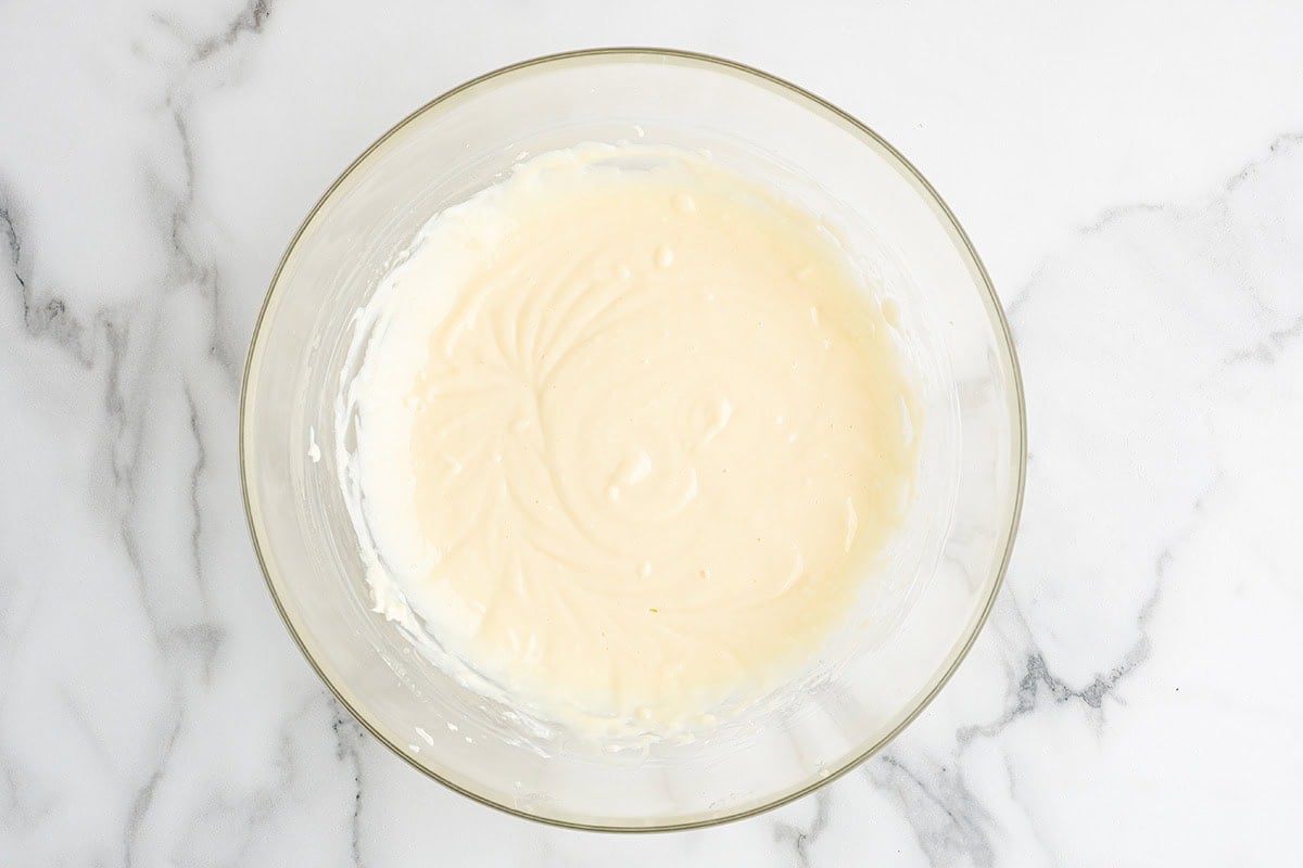 Smooth creamy millionaire pie filling in a glass mixing bowl.