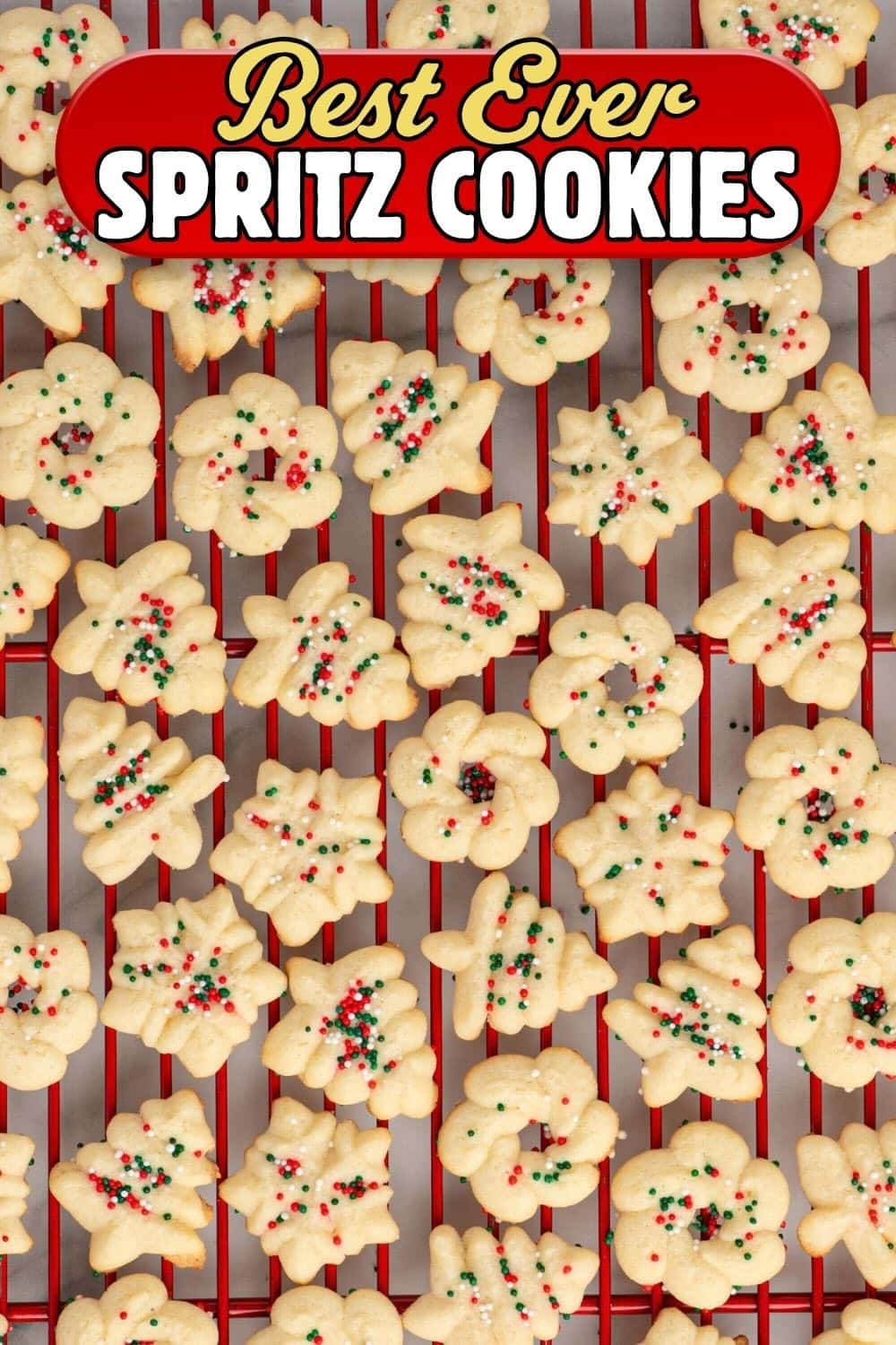 Best ever spritz cookies with red and green sprinkles on a red cooling rack.